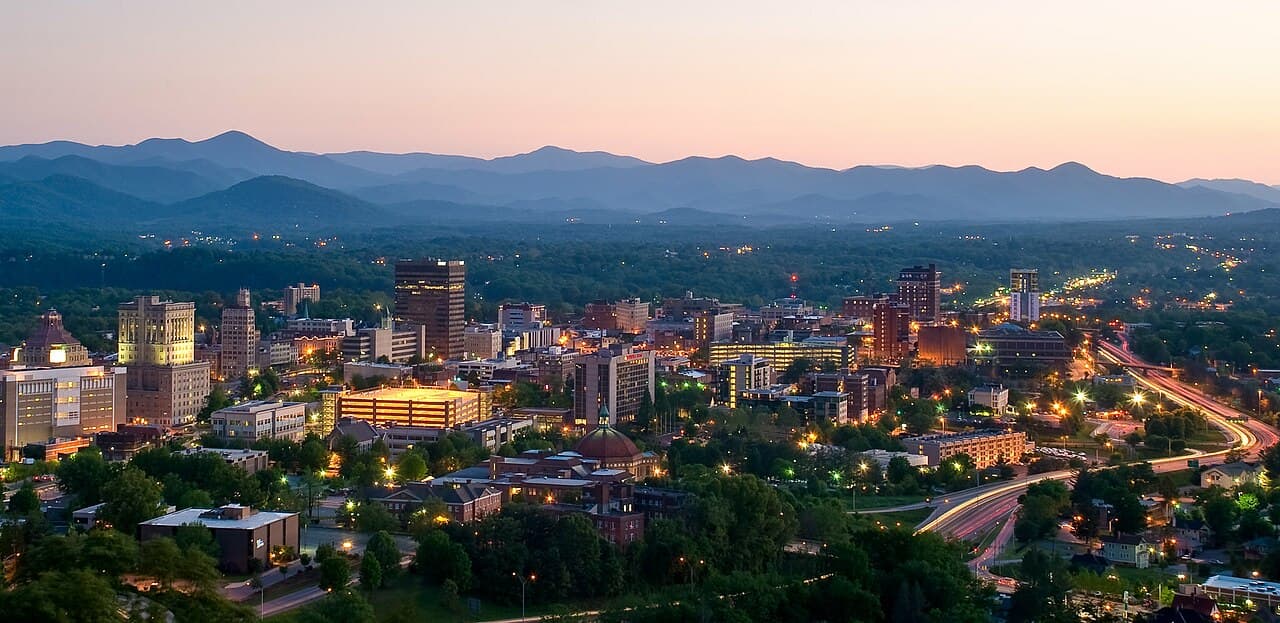 Downtown Asheville at dusk with Blue Ridge Mountains